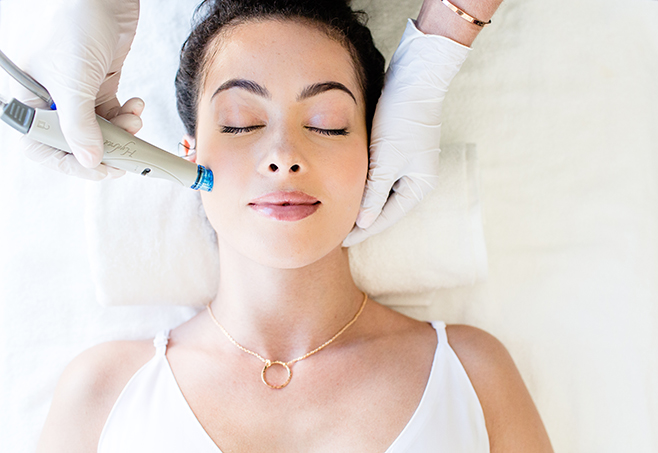 Woman receiving microneedling treatment