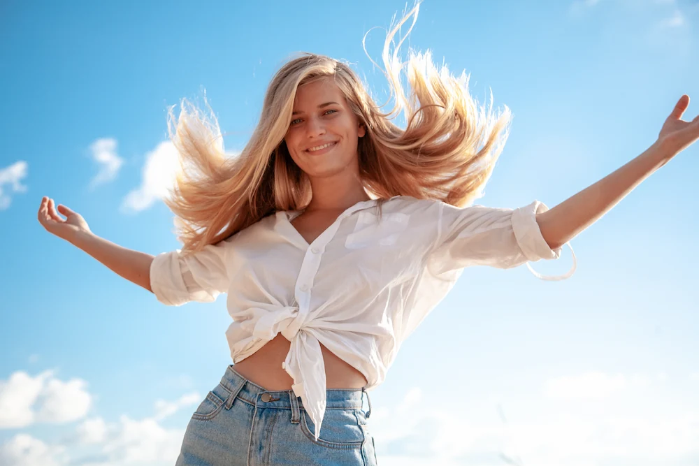 Blonde woman with luscious hair at the beach