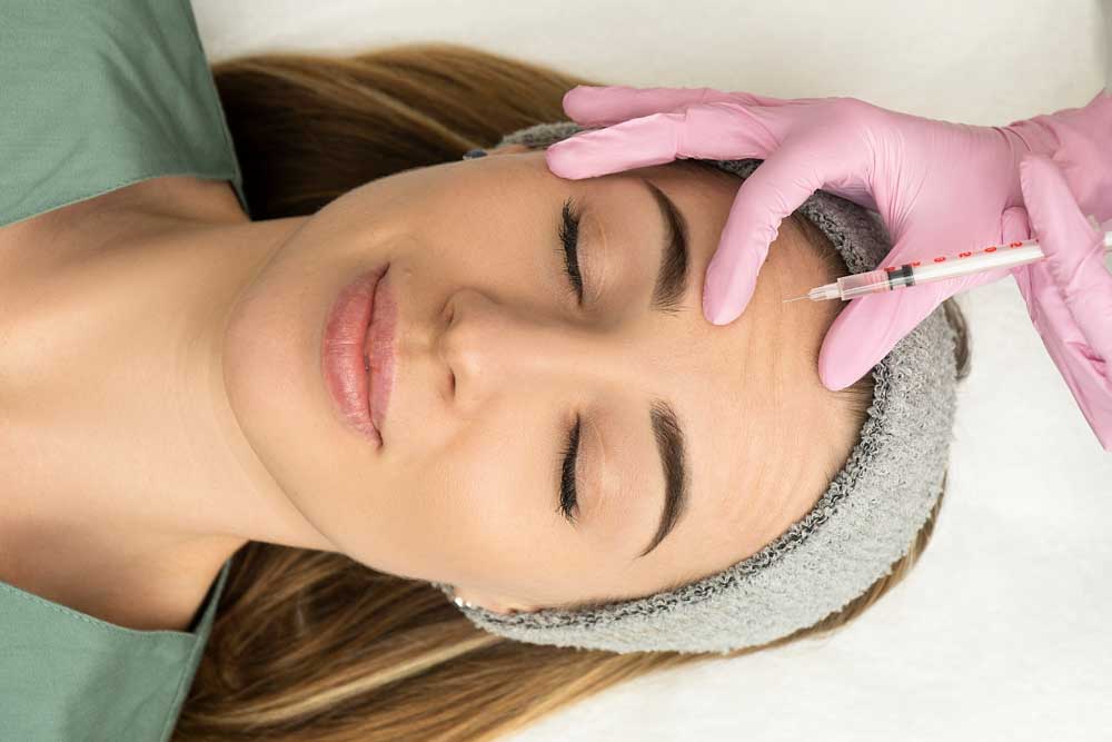 woman receiving an injection on her face