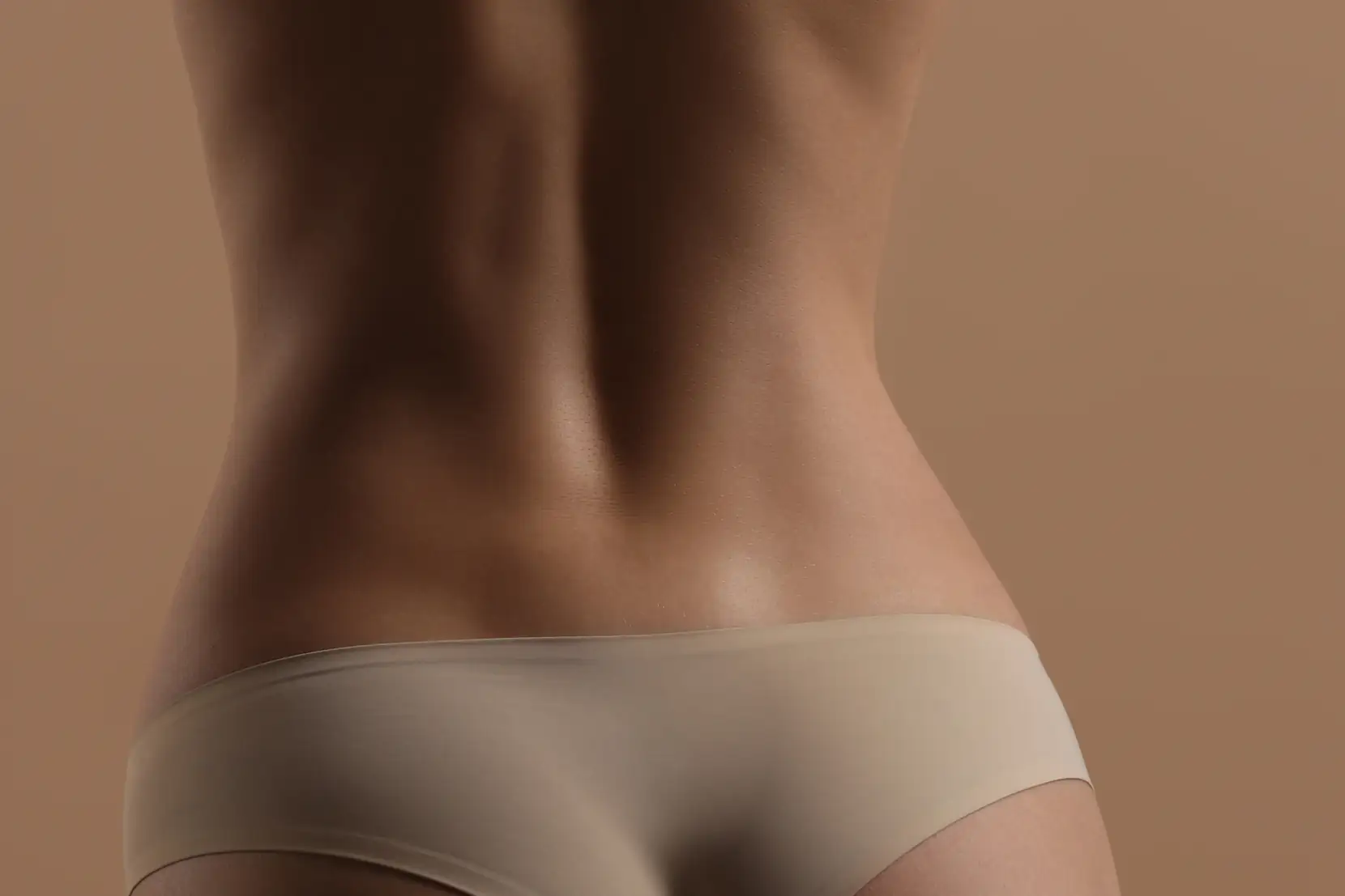 Woman's smooth, evenly toned lower back and skin